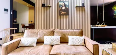 a living room with a brown couch with pillows at Home Sweet House in Hermée