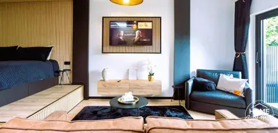 a living room with a couch and a bed at Home Sweet House in Hermée