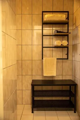 a bathroom with a table and a tiled wall at Tussen Heide en Bos in het Nationaal Park Hoge Kempen in Oudsbergen