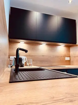 a kitchen with a sink and a tv on a counter at Cosy Of John Cockerill 2 in Seraing