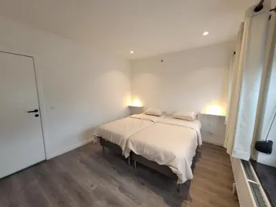 a bedroom with a bed with two pillows on it at Biesenbilzen in Bilzen