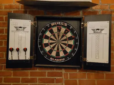 a dart board on a brick wall with darts at Biesenbilzen in Bilzen