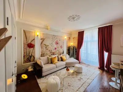 a living room with a white couch and red curtains at L'haussmanien romantique - HEC, Jardin botanique in Liège