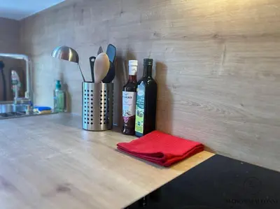 a counter with two bottles of wine and a red napkin at L'haussmanien romantique - HEC, Jardin botanique in Liège