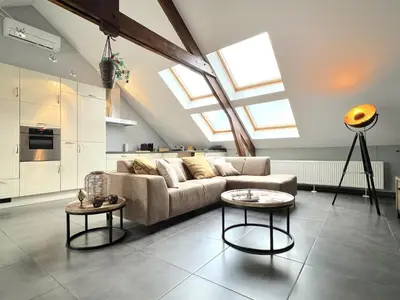 a living room with a couch and two tables at t Vennehuisje in Genk