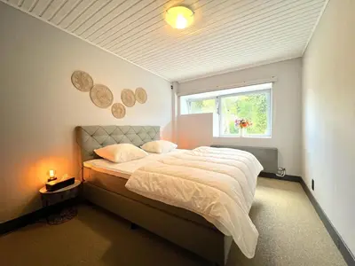 a bedroom with a bed and a window in it at t Vennehuisje in Genk