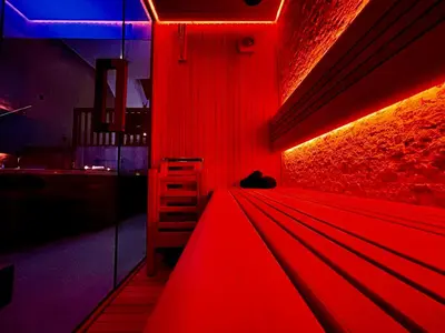 a red room with a chair and a red light at Pause Thermale Suites Deluxe et Spa Privatif in Herstal