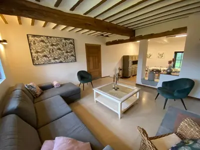 a living room with a couch and a table at Gite 13 personnes in Battice