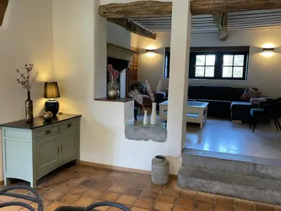 a living room with a couch and a table and chairs at Gite 13 personnes in Battice