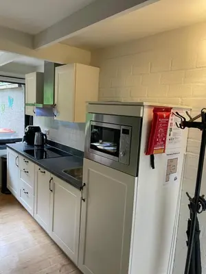 a kitchen with a microwave on top of a refrigerator at Vakantiehuis Lanaken in Lanaken