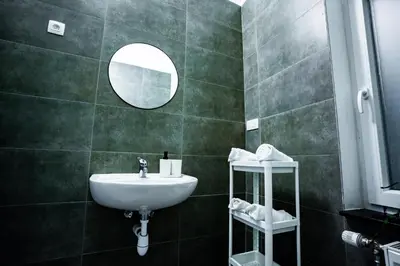 a bathroom with a sink and a mirror at Chambre R1 avec salle de bain privée in Liège