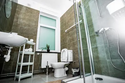 a bathroom with a sink and a toilet and a shower at Chambre R1 avec salle de bain privée in Liège