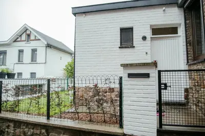 a white house with a fence in front of it at La Courte Échelle in Verviers