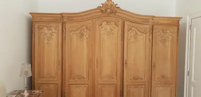 a large wooden cabinet in a room at Just for sleep in Liège