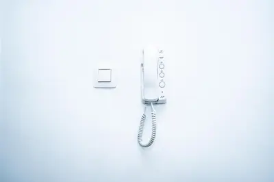 a hair dryer hanging on a white wall at Chambre R1 avec salle de bain partagée près de l'hôpital de la Citadelle à Liège in Liège