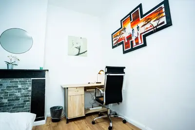 an office with a desk and a chair in a room at Chambre R1 avec salle de bain partagée près de l'hôpital de la Citadelle à Liège in Liège
