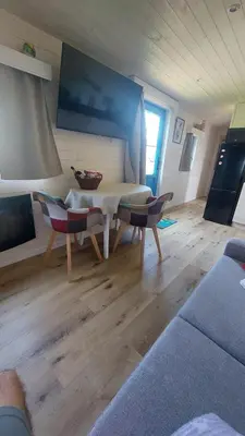 a living room with a couch and a table and chairs at Puck B&B Babbita in Hasselt