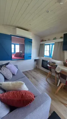 a living room with a couch and a dining room at Puck B&B Babbita in Hasselt