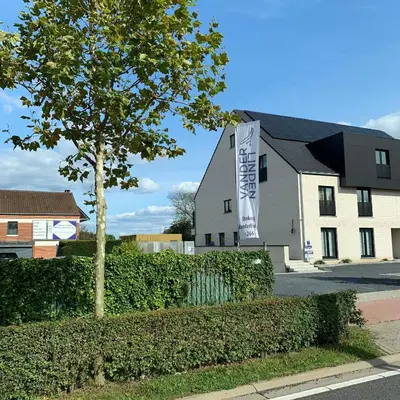 a building with a banner in front of it at DeStoker in Hasselt