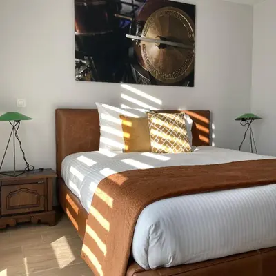 a bedroom with a bed and a clock on the wall at DeStoker in Hasselt