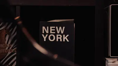 a new york book sitting on a shelf at La Suite Gold Wellness Jacuzzi & Sauna in Seraing