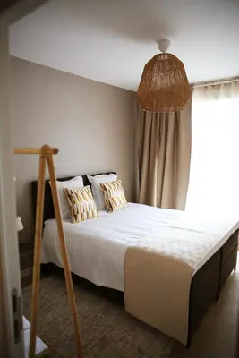 a bedroom with a bed and a window at Le 118 Guillemins, avec Parking in Liège