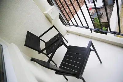 a black chair sitting on top of a balcony at Le 118 Guillemins, avec Parking in Liège