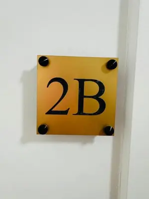 a yellow sign with the number on a door at Urbanchic Opéra 2B in Liège