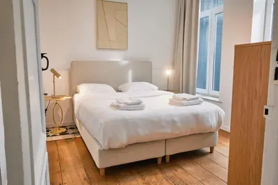 a bedroom with a large bed with towels on it at Urbanchic Appartement élégance hyper centre in Liège