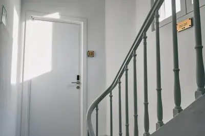 a white door with a sign that reads exit at Urbanchic Appartement élégance hyper centre in Liège
