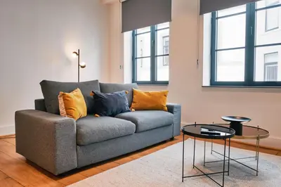 a living room with a couch and a table at Urbanchic atmosphère 2D in Liège