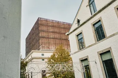 a tall brick building next to two buildings at Urbanchic atmosphère 2D in Liège