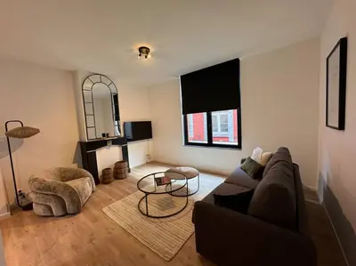a living room with a couch and a table at Urbanchic Appartement cosy 1B in Liège