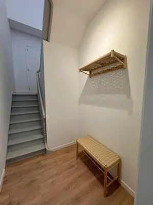 a stairway with a bench in a room with stairs at Urbanchic Appartement cosy 1B in Liège