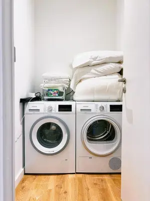 two washing machines and a washer and dryer in a room at Urbanchic Appartement cosy 1B in Liège