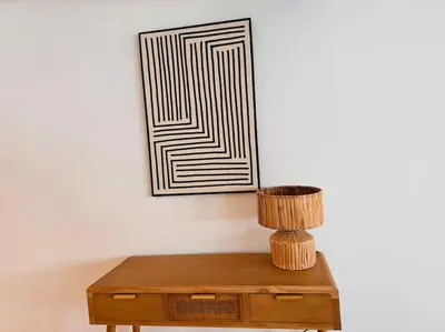 a wooden table with a lamp and a picture on the wall at Urbanchic Appartement Evasion 3D in Liège