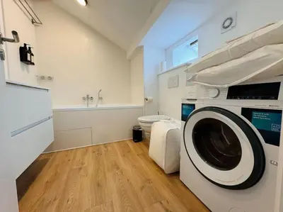 a bathroom with a washing machine in a room at Urbanchic Appartement Evasion 3D in Liège