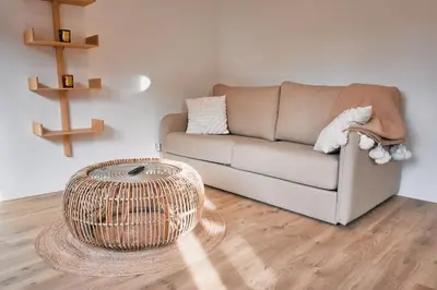 a living room with a couch and a table at Urbanchic Appartement Chill 3B in Liège