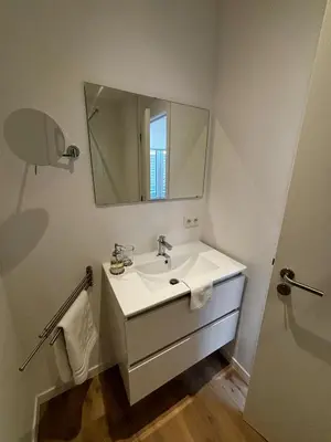 a bathroom with a sink and a mirror at Urbanchic Appartement Chill 3B in Liège