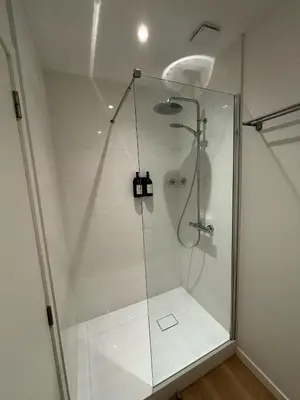 a shower with a glass door in a bathroom at Urbanchic Appartement Chill 3B in Liège