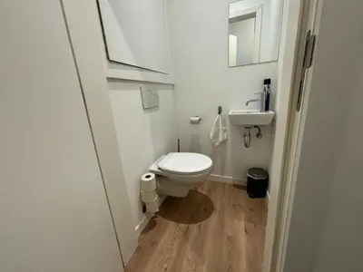 a small bathroom with a toilet and a sink at Urbanchic Appartement Chill 3B in Liège