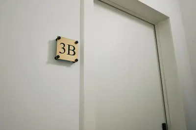a clock on the side of a white door at Urbanchic Appartement Chill 3B in Liège