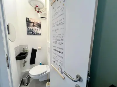 a bathroom with a toilet with writing on the wall at Modern Business Flat - Courts et moyens séjours in Liège