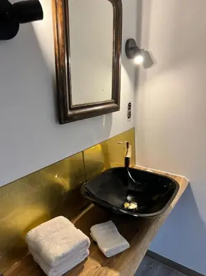 a bathroom with a black sink and a mirror at Das GANZE Chateau Thor - bis zu 22 Personen in Lontzen