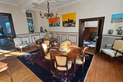 a living room with a dining room table and chairs at Das GANZE Chateau Thor - bis zu 22 Personen in Lontzen