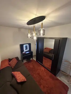 a living room with a couch and a mirror at Puur17 in Lommel