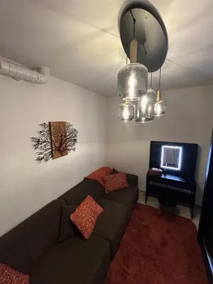 a living room with a couch and a tv at Puur17 in Lommel
