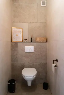 a bathroom with a white toilet in a room at Puur17 in Lommel