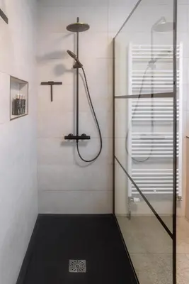 a shower with a glass door in a bathroom at Puur17 in Lommel
