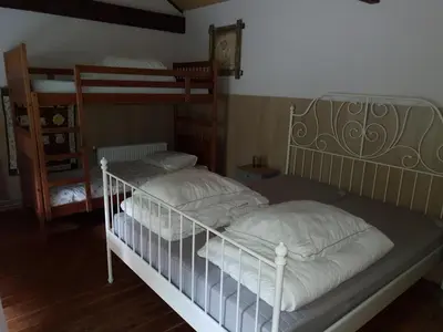 a bedroom with two bunk beds in a room at B&B Land of Tir Nan Og in Lommel